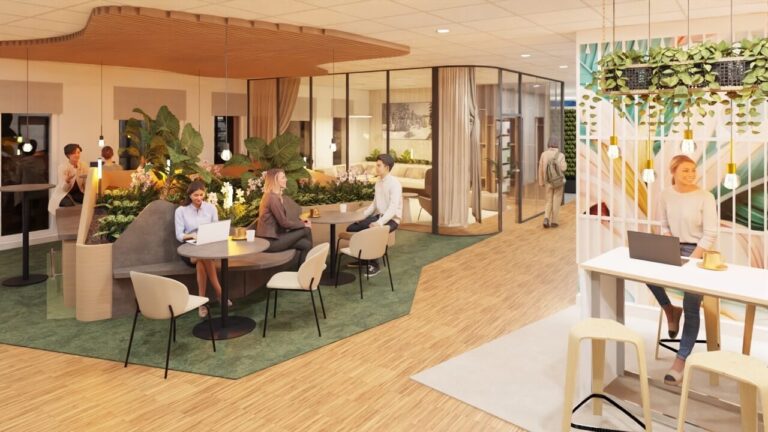 Menschen arbeiten in einem modernen Büro mit Pflanzen und Holzelementen.